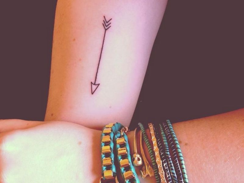 10. Arrow Tattoo Designs with Symbols for Women - wide 8
