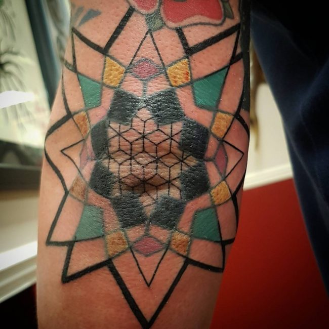 What is the significance of spider web tattoos on elbows?
