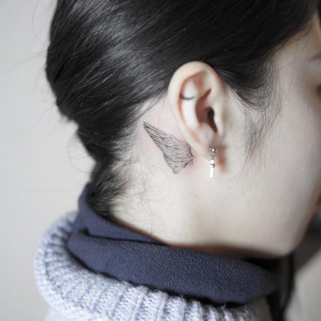 Butterfly wing behind ear tattoo