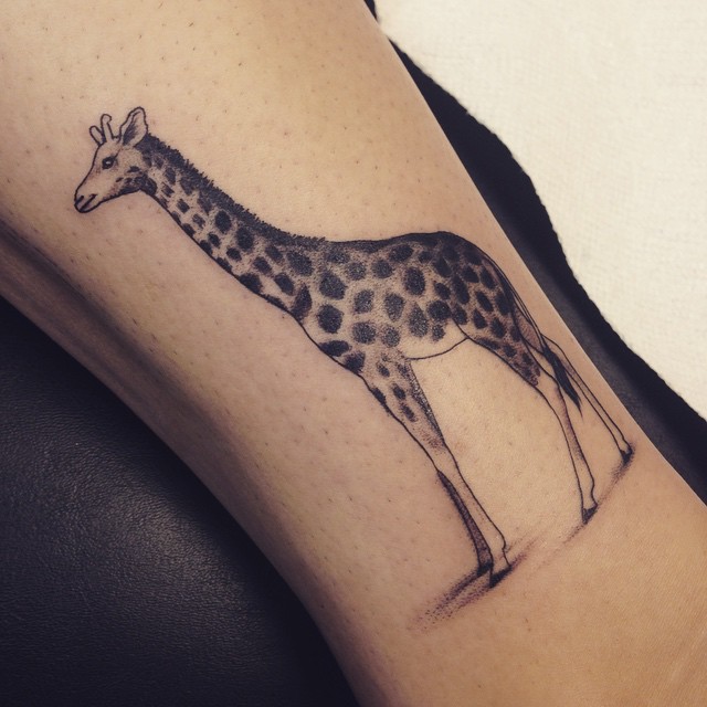 The zookeeper having a giraffe with her tattoos