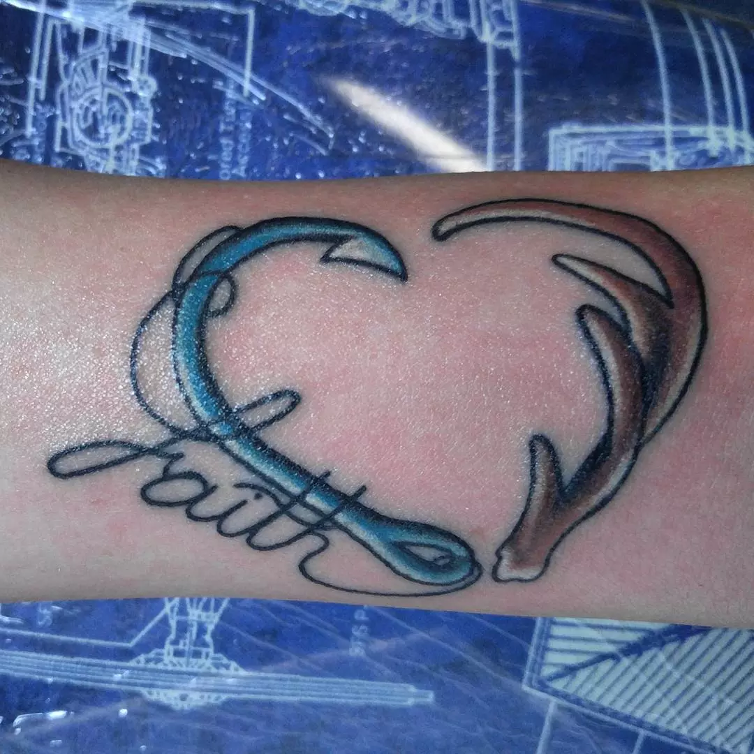 Fish hook and antler heart tattoo. 